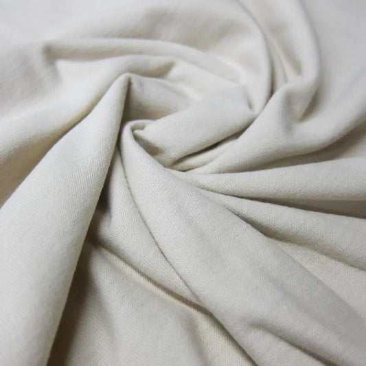 Close-up of draped cream-colored organic cotton fabric from Nature's Fabrics
