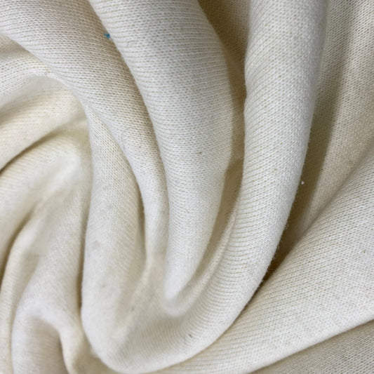 Close-up of draped cream-colored organic cotton fabric from Nature's Fabrics