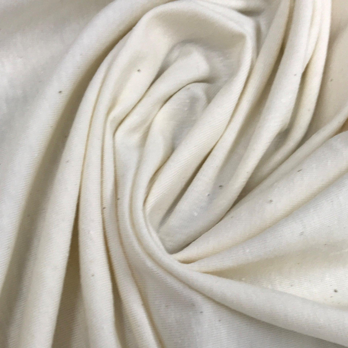 Close-up of draped white organic cotton fabric from Nature's Fabrics