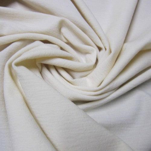 Close-up of draped cream-colored natural fabric from Nature's Fabrics.