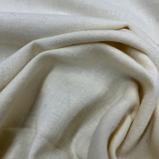 Close-up of draped, cream-colored organic cotton fabric from Nature's Fabrics.