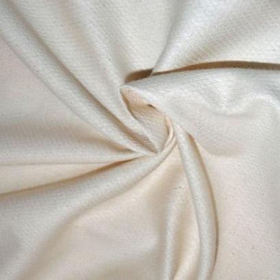 Close-up of draped cream-colored organic cotton fabric from Nature's Fabrics.