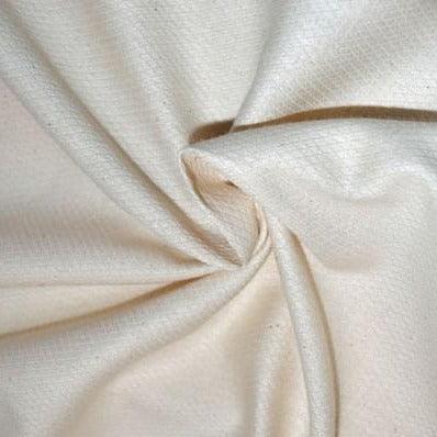 Close-up of draped cream-colored natural organic cotton fabric from Nature's Fabrics