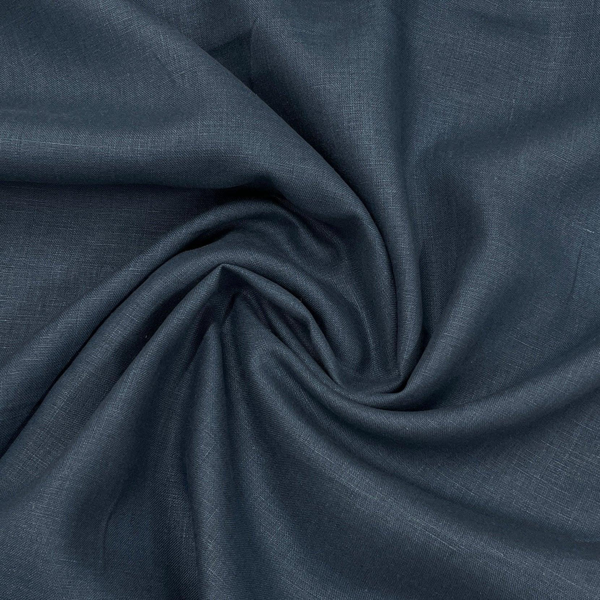 Nature's Fabrics dark grey-blue natural fabric draped in a swirl