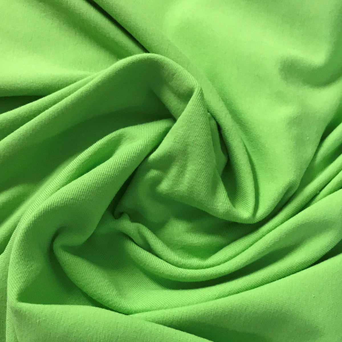 Close-up of draped lime green natural fabric from Nature's Fabrics