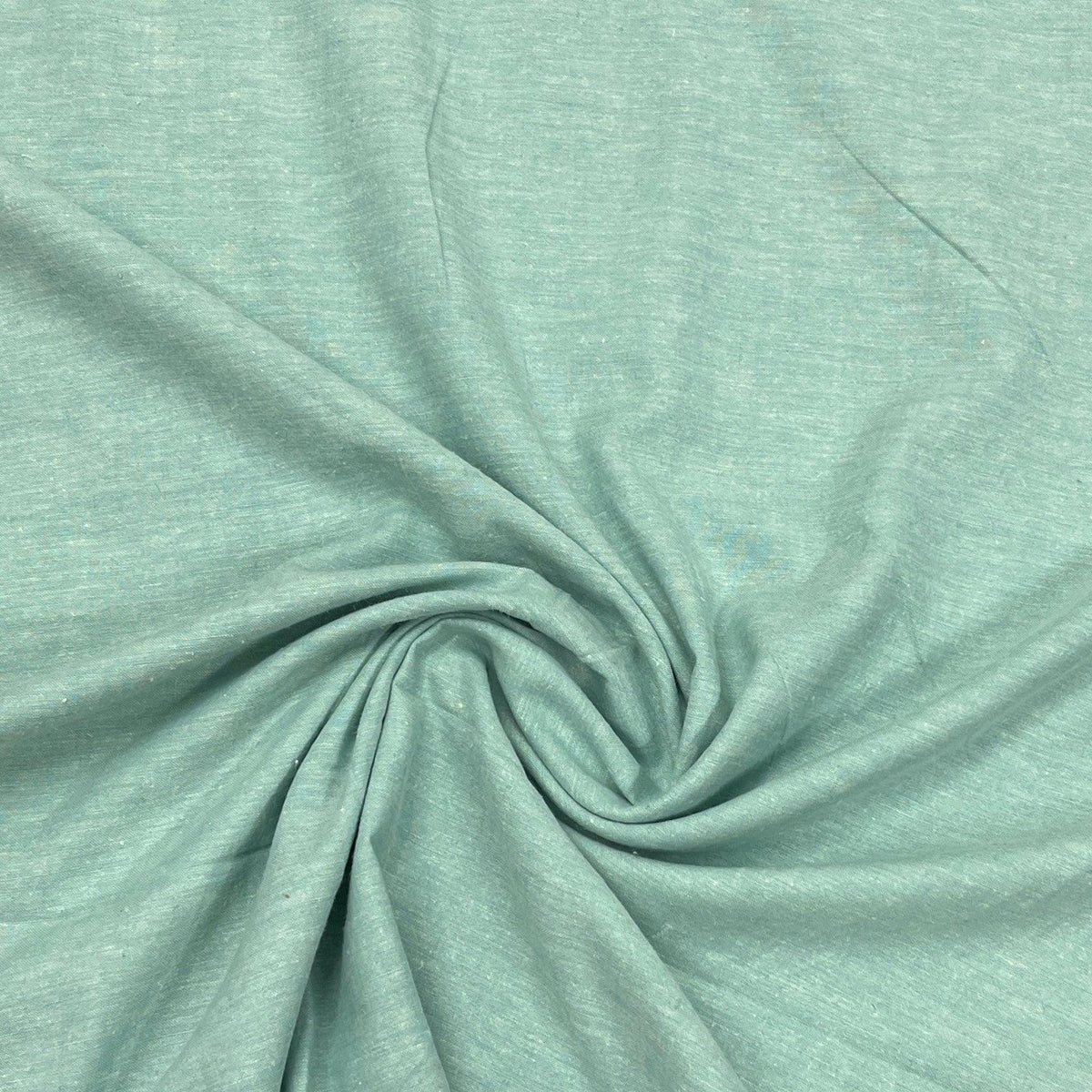 Nature's Fabrics light seafoam green natural fabric draped in a spiral fold.
