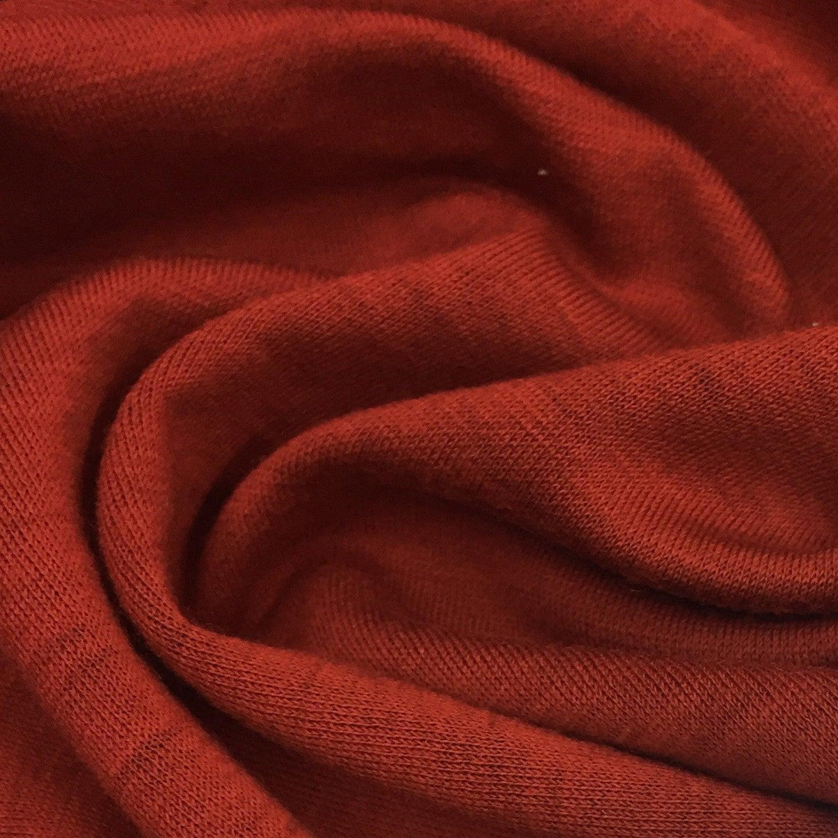Close-up of draped red organic cotton fabric from Nature's Fabrics