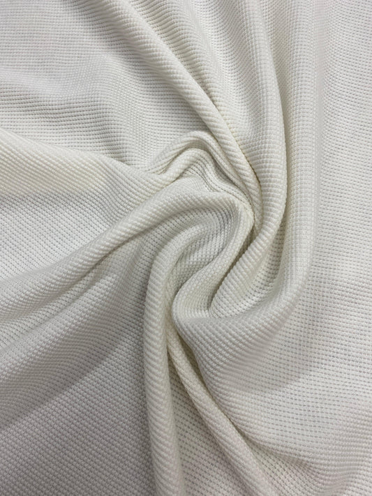 Close-up of draped white textured natural fabric from Nature's Fabrics.