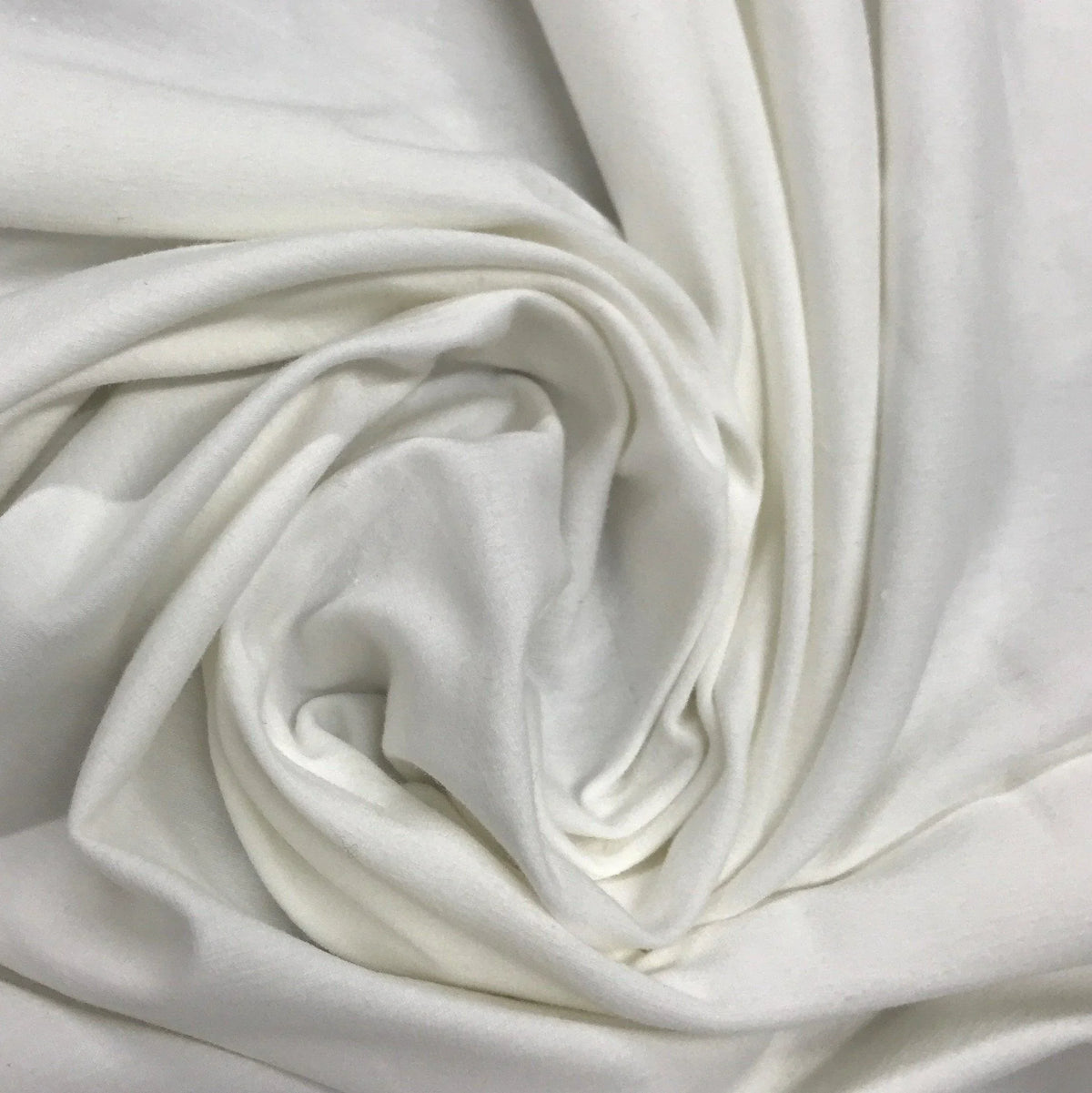 Close-up of swirled white organic cotton fabric from Nature's Fabrics.