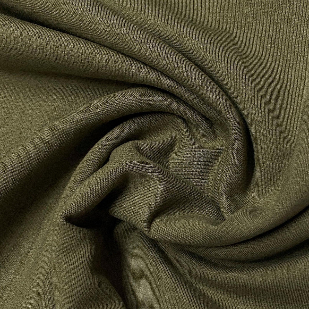 Close-up of olive green draped natural fabric from Nature's Fabrics