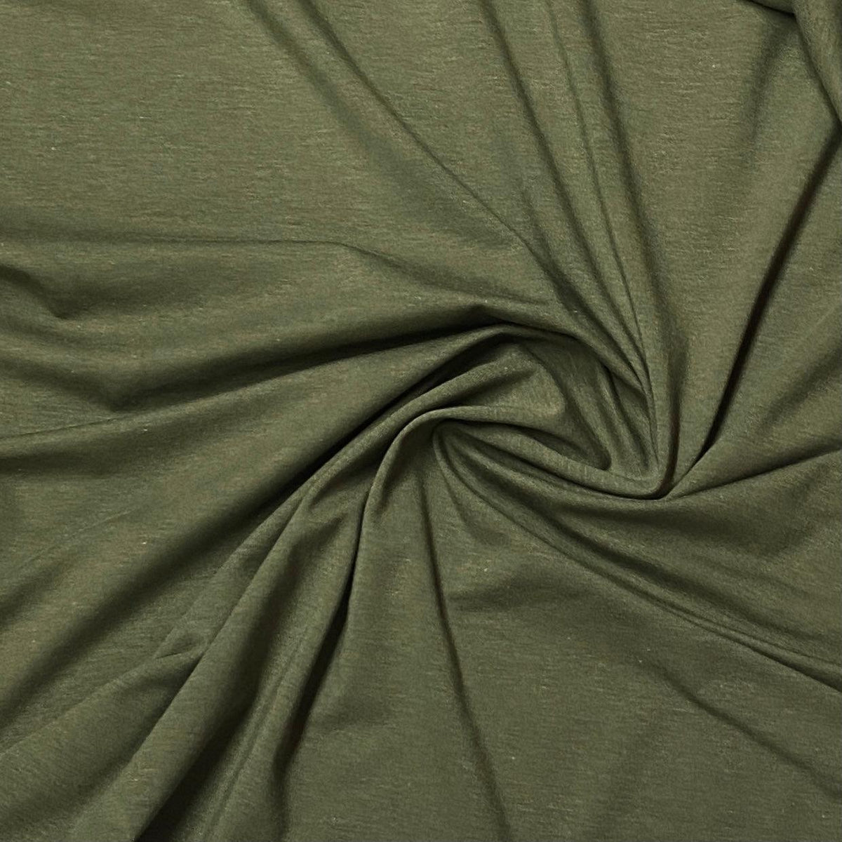 Olive green natural fabric from Nature's Fabrics draped in a spiral swirl.