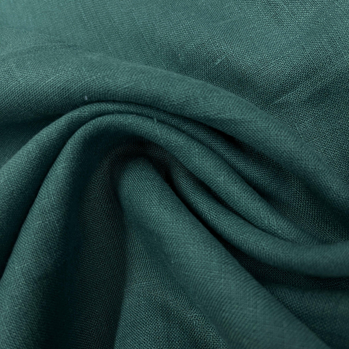Close-up of draped deep teal green natural fabric from Nature's Fabrics