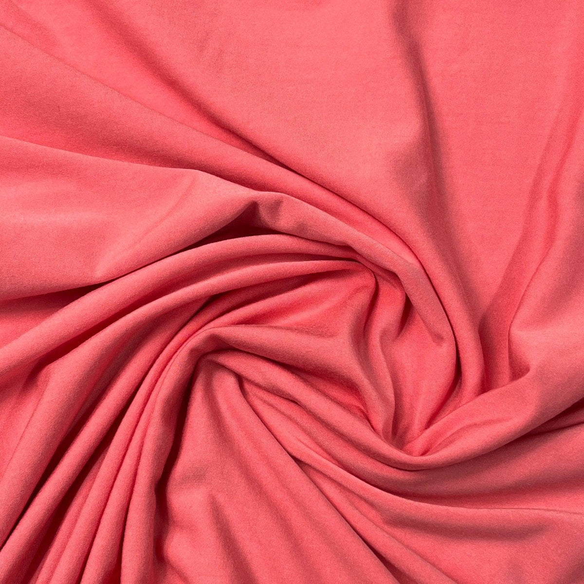 Swirl of coral pink premium natural fabric from Nature's Fabrics.