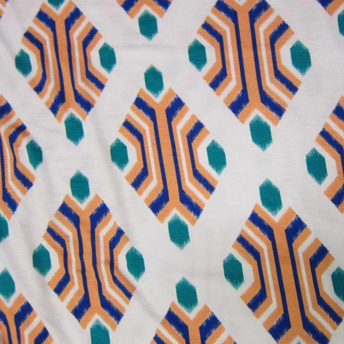 Nature's Fabrics organic cotton fabric with blue, orange, and teal geometric ikat pattern