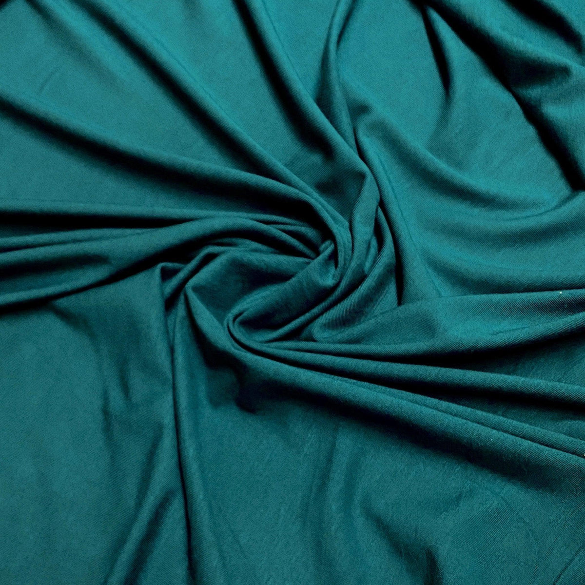 Nature's Fabrics teal green draped natural fabric with soft folds