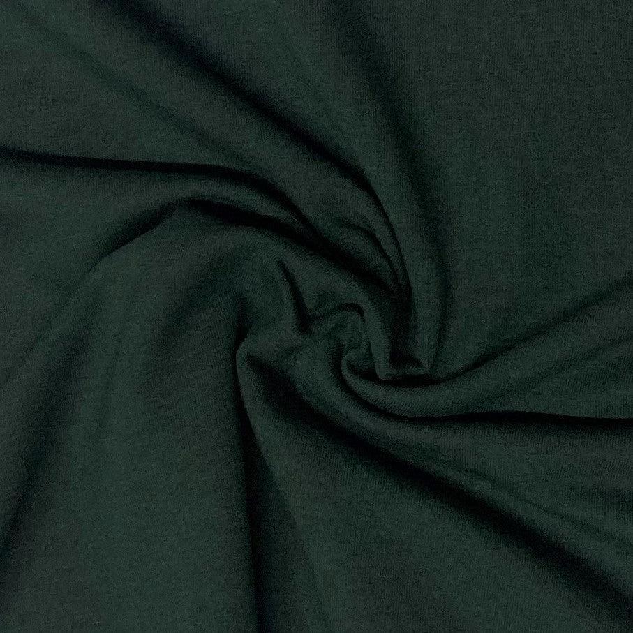 Dark green natural fabric from Nature's Fabrics draped in a swirl