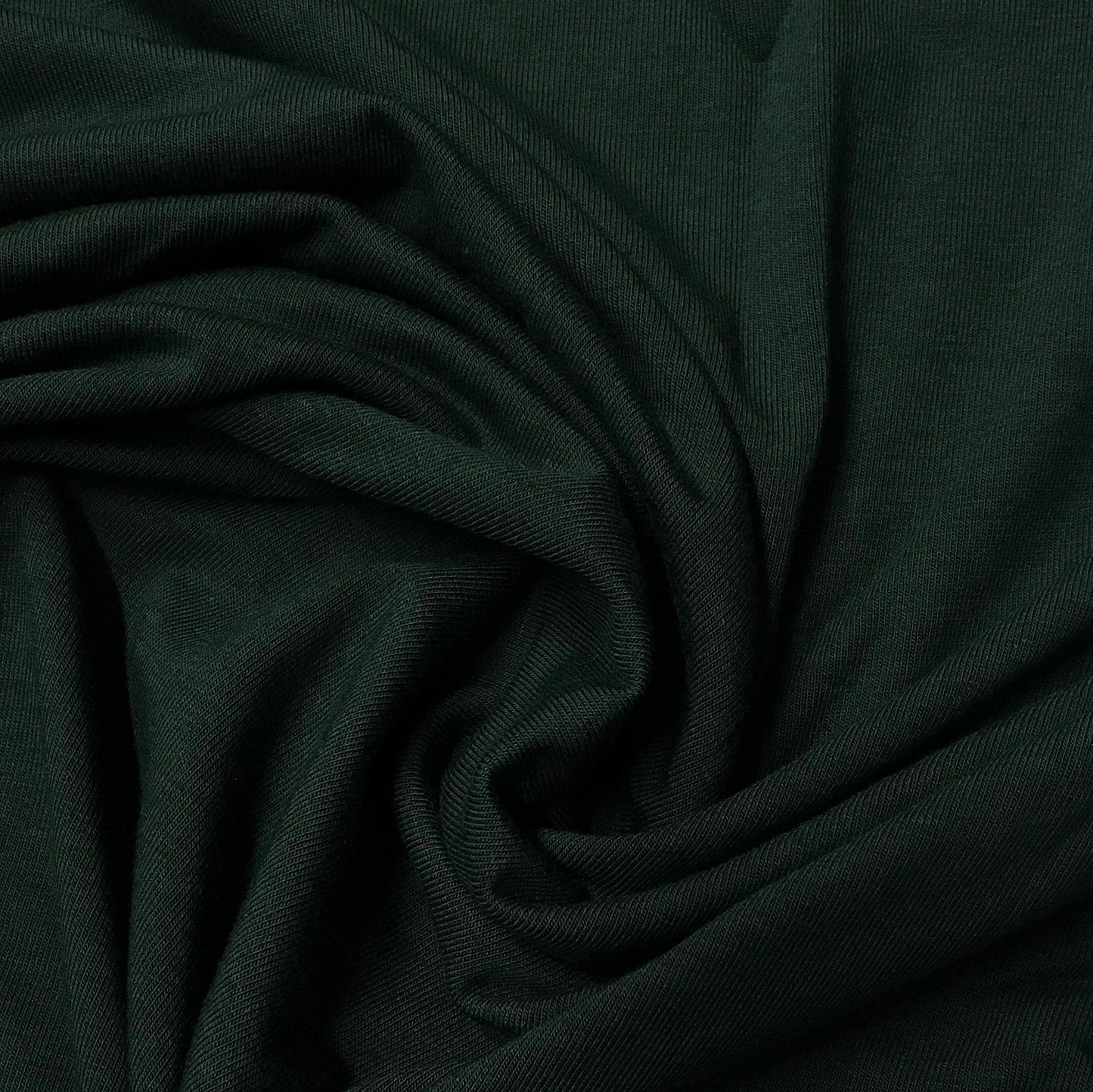 Dark green organic fabric draped in soft folds from Nature's Fabrics