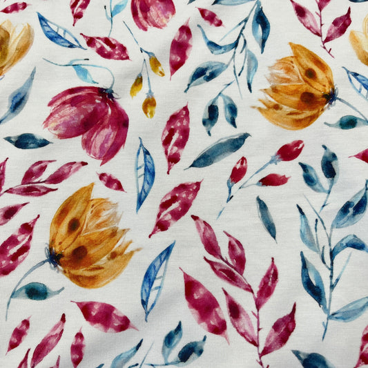 Nature's Fabrics organic cotton with red, yellow, and blue watercolor floral pattern.