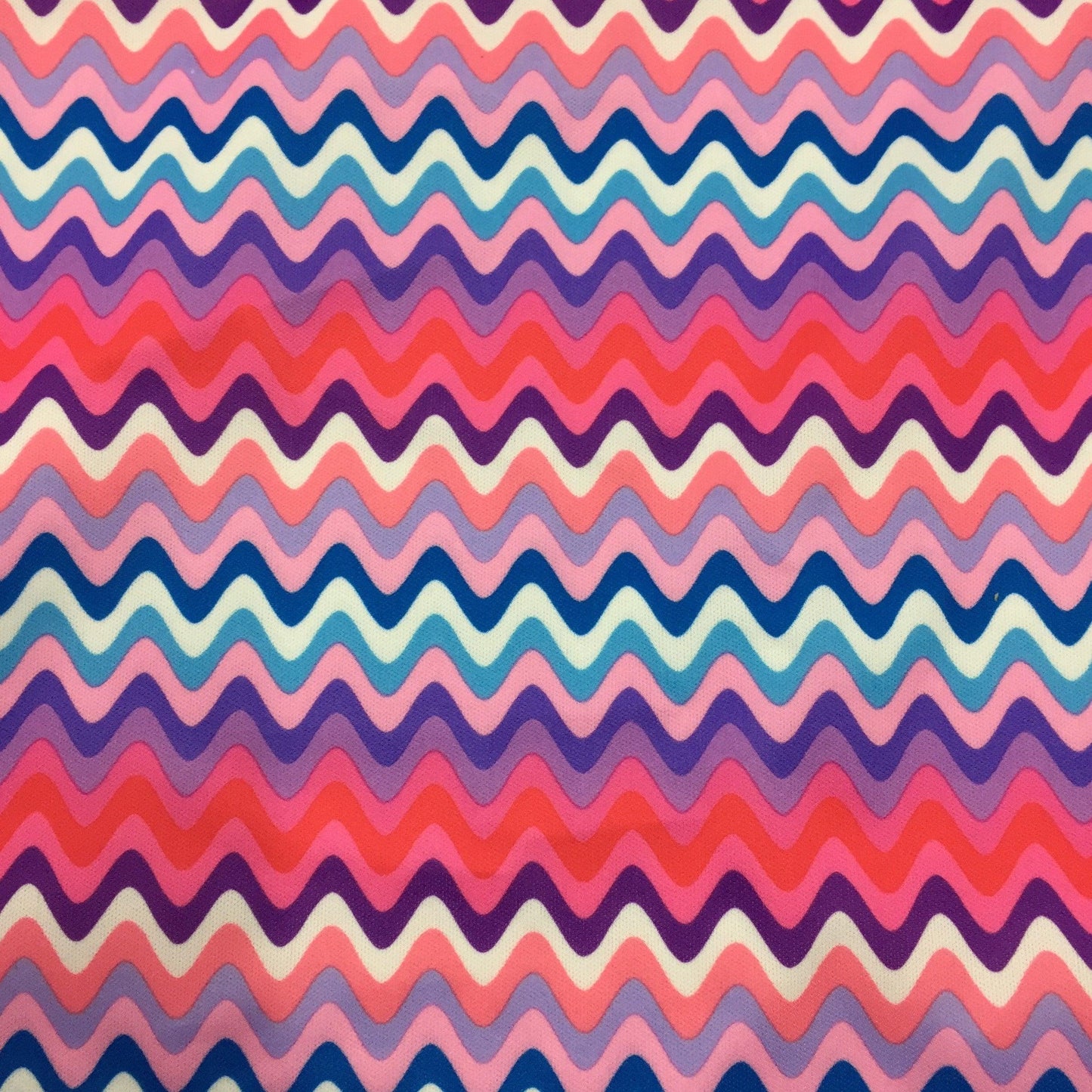 Nature's Fabrics multicolored wavy chevron pattern fabric in pink, purple, and blue