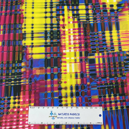 Colorful abstract patterned fabric from Nature's Fabrics with a measuring ruler for scale.