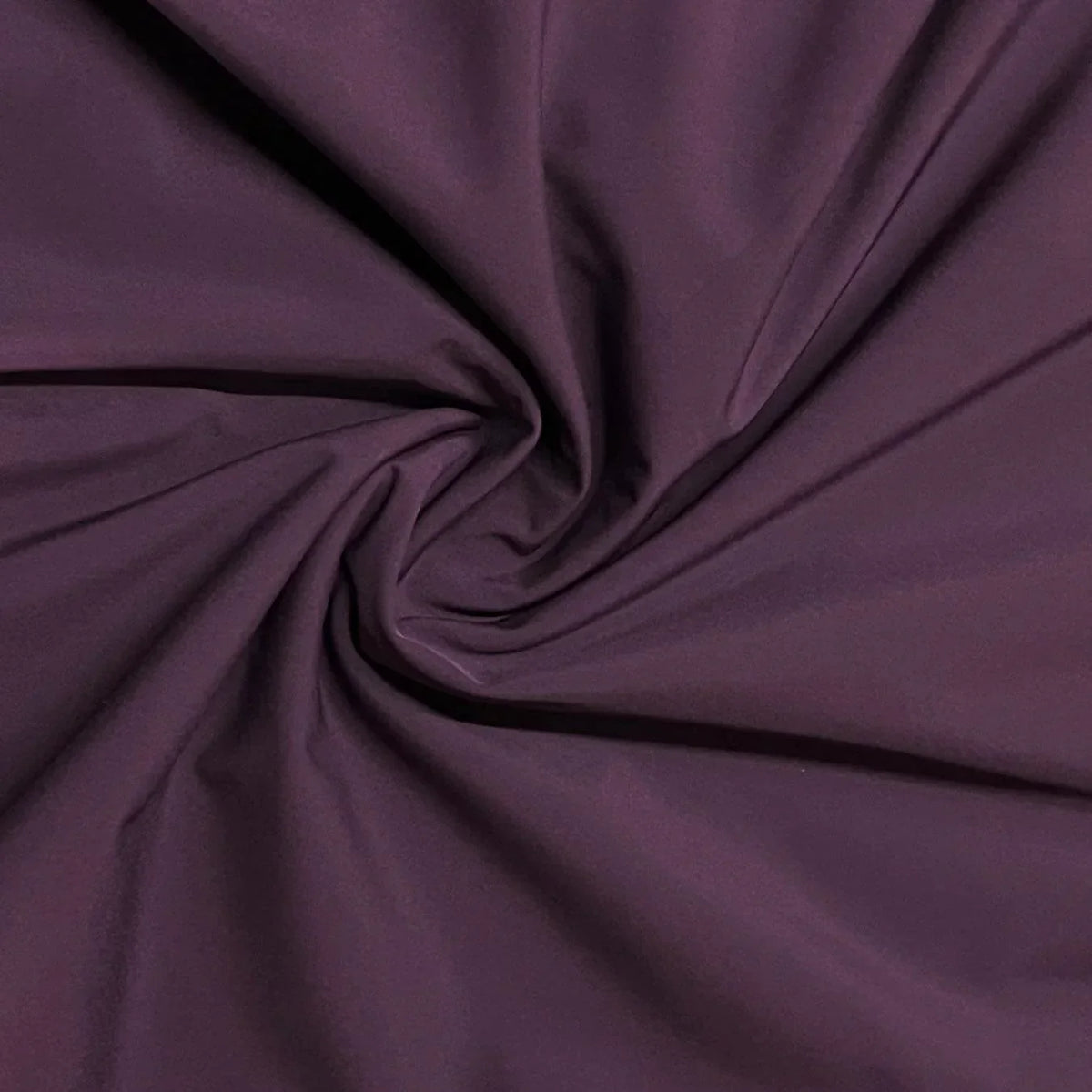 Close-up of draped purple natural fabric by Nature's Fabrics