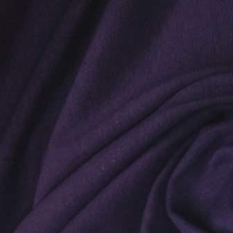 Close-up of deep purple natural fabric draped in folds from Nature's Fabrics.
