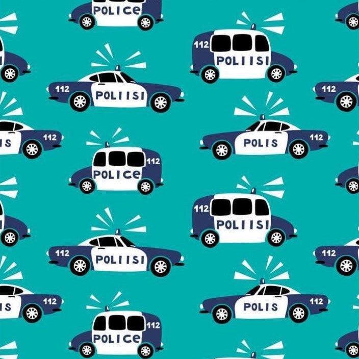 Nature's Fabrics pattern featuring blue and white police cars on a teal background.