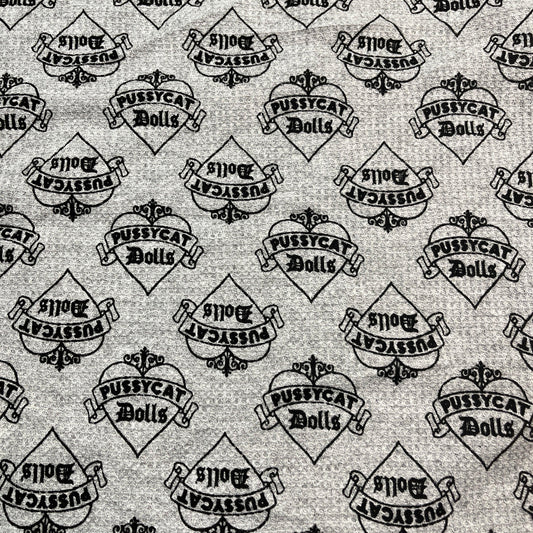 Grey Nature's Fabrics textile featuring a repeating Pussycat Dolls logo heart pattern.