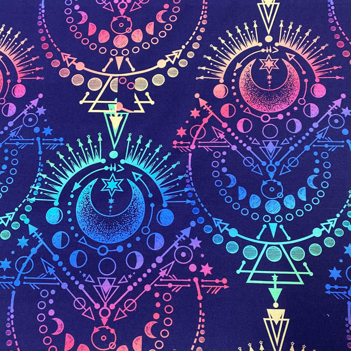 Nature's Fabrics celestial print fabric featuring moons, stars, and geometric patterns in neon colors.