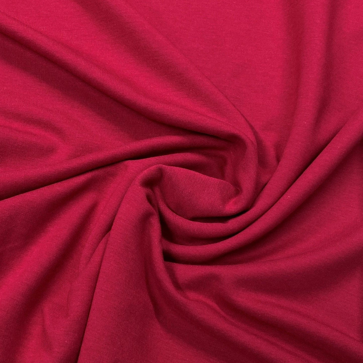 Swirled texture of premium red organic cotton fabric from Nature's Fabrics