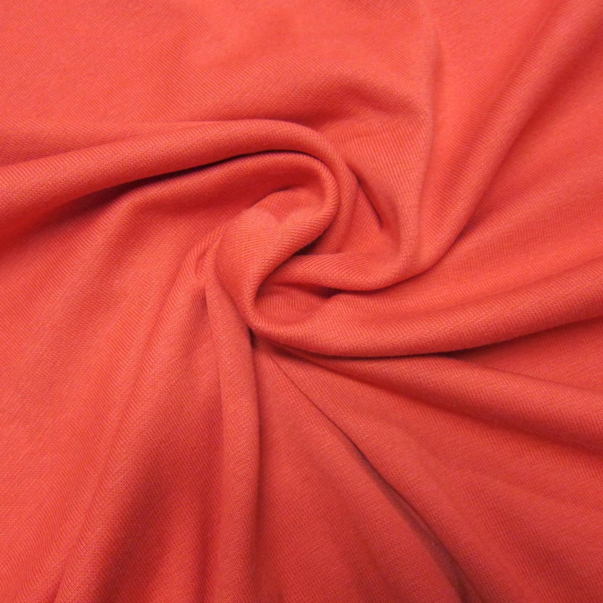 Close-up of swirled, coral-red natural fabric from Nature's Fabrics