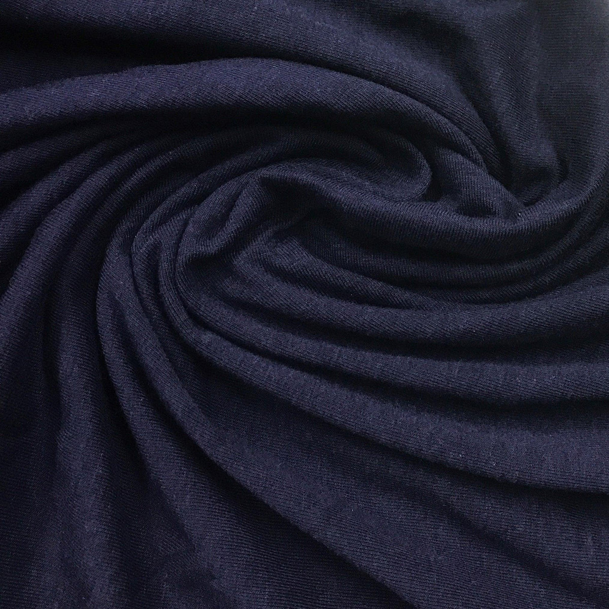 Nature's Fabrics navy blue organic cotton fabric draped in a swirl pattern