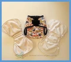 Nature's Fabrics reusable cloth diapers, including one printed and two plain white options.
