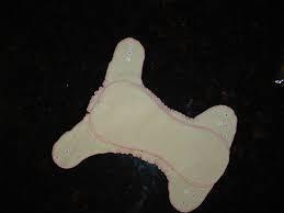 Nature's Fabrics reusable cloth menstrual pad on a dark background