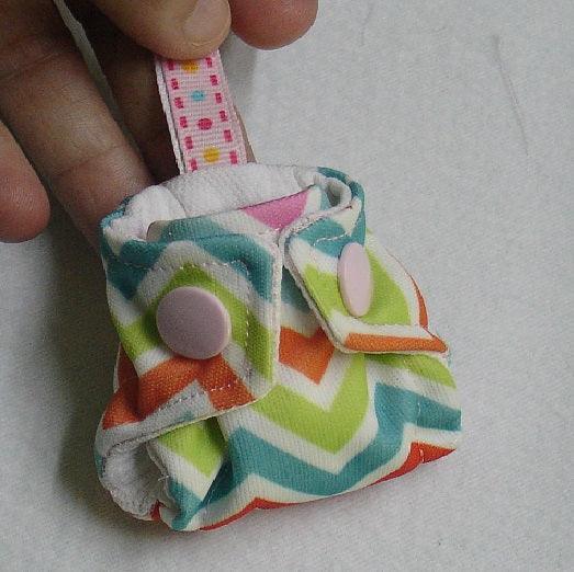 Nature's Fabrics colorful chevron pattern fabric accessory with pink buttons.