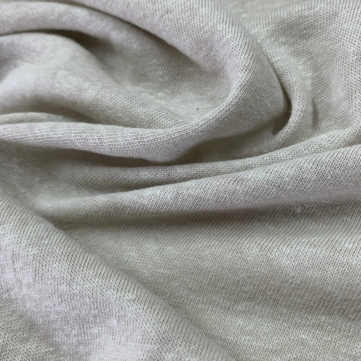 Close-up of draped, off-white organic cotton fabric from Nature's Fabrics