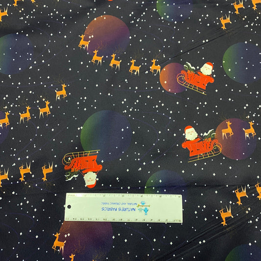 Nature's Fabrics holiday fabric with Santa, reindeer, and stars on a dark starry background