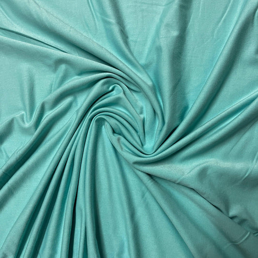 Swirl of premium turquoise natural fabric from Nature's Fabrics.