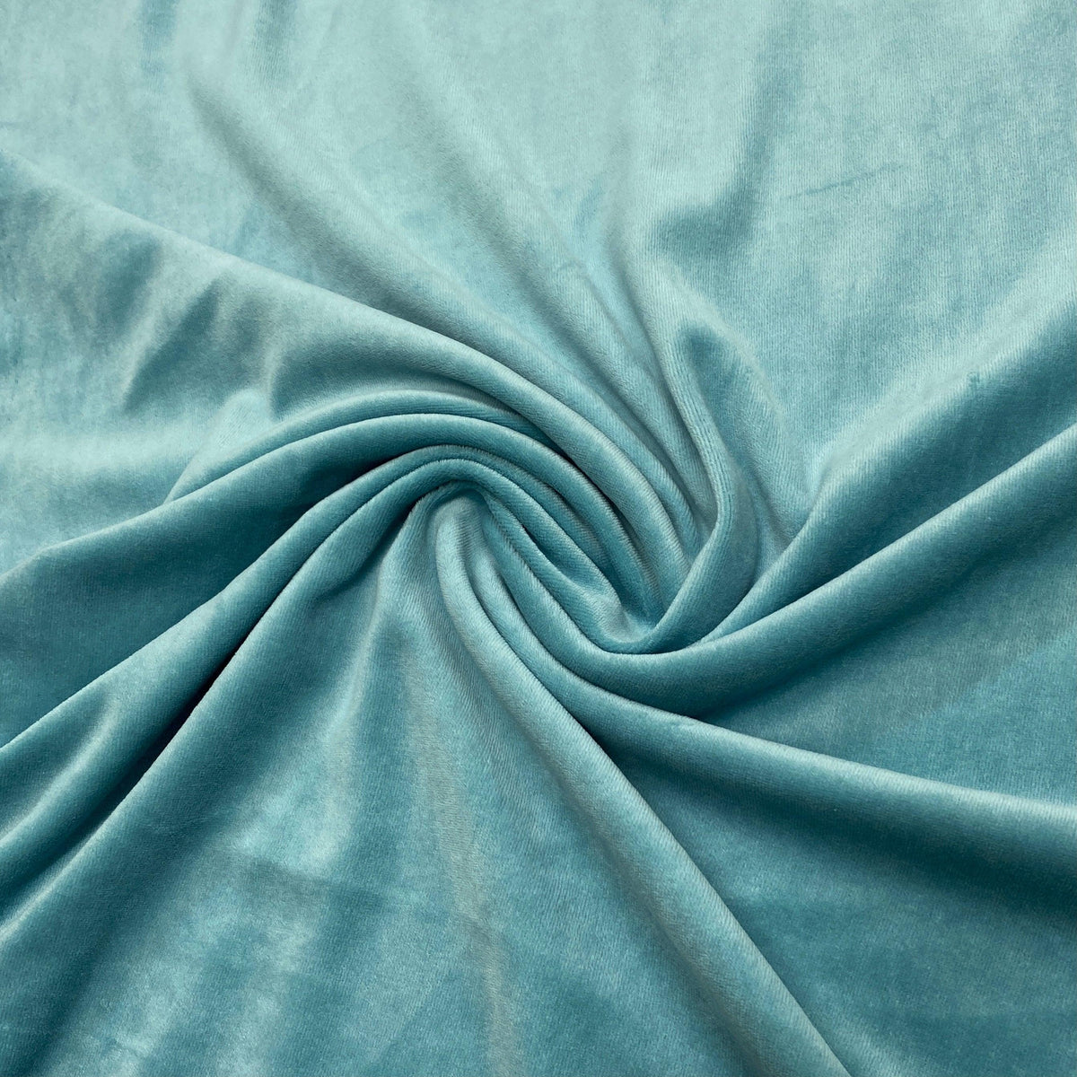 Swirl of premium teal velvet fabric from Nature's Fabrics.