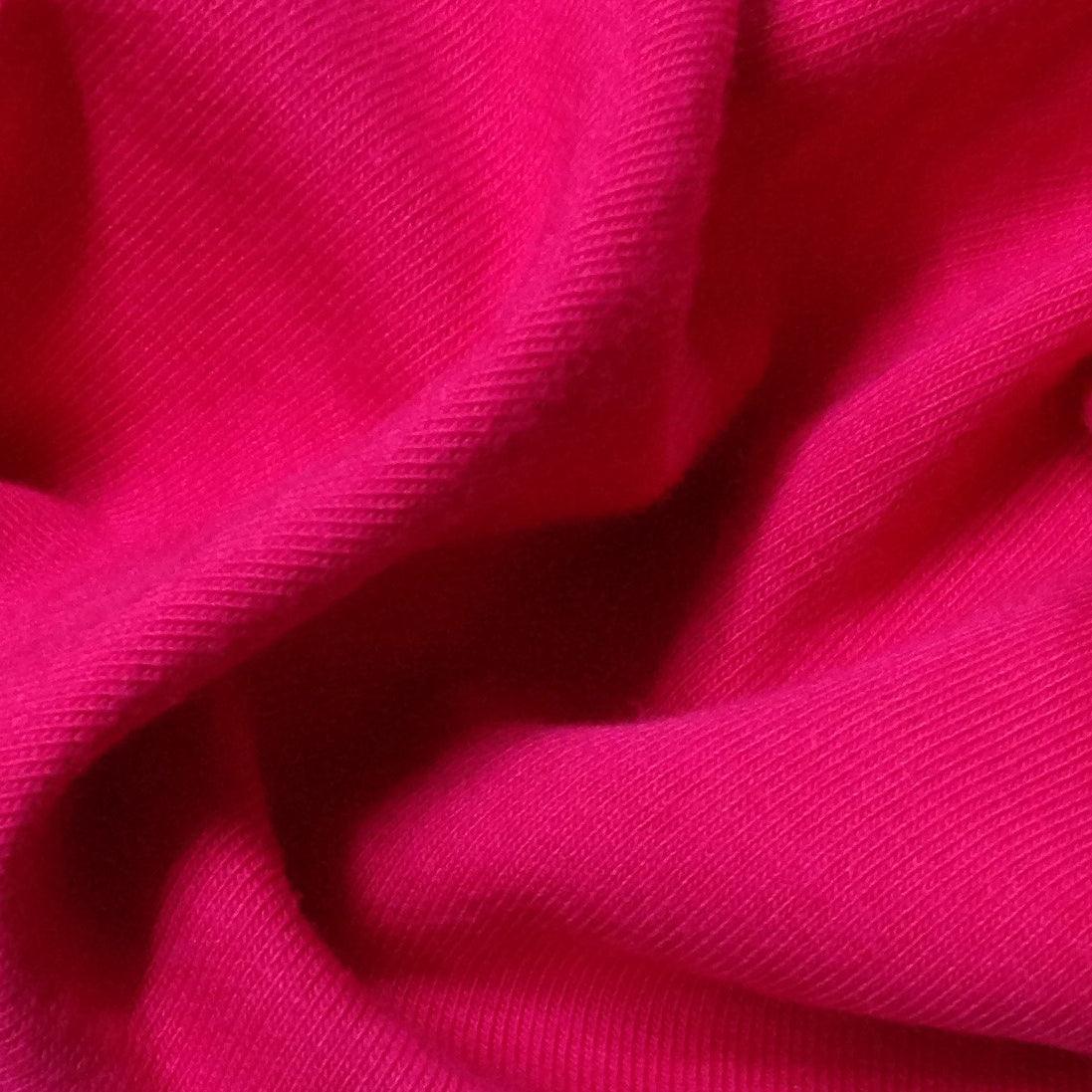 Close-up of vibrant pink Nature's Fabrics textured fabric with soft folds.