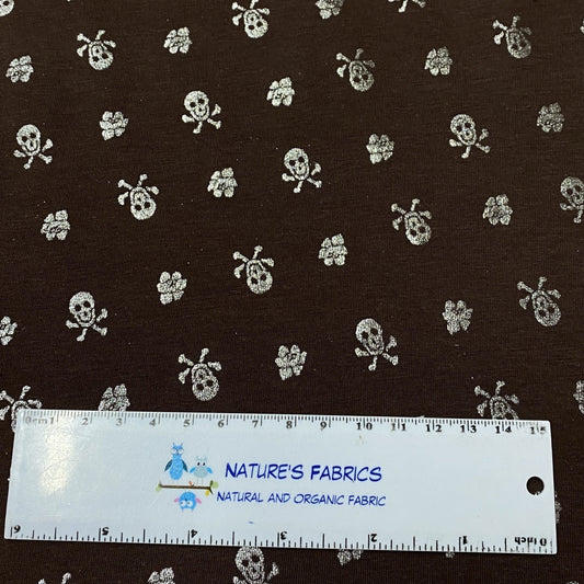 Silver Skulls on Brown Cotton/Spandex Jersey Fabric - Nature's Fabrics