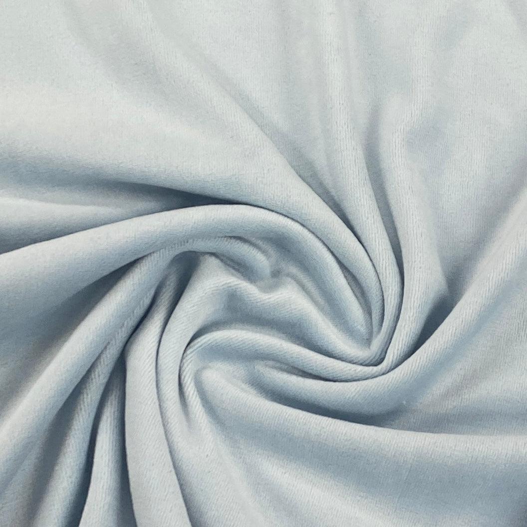Close-up of light blue Nature's Fabrics premium natural fabric with soft folds.