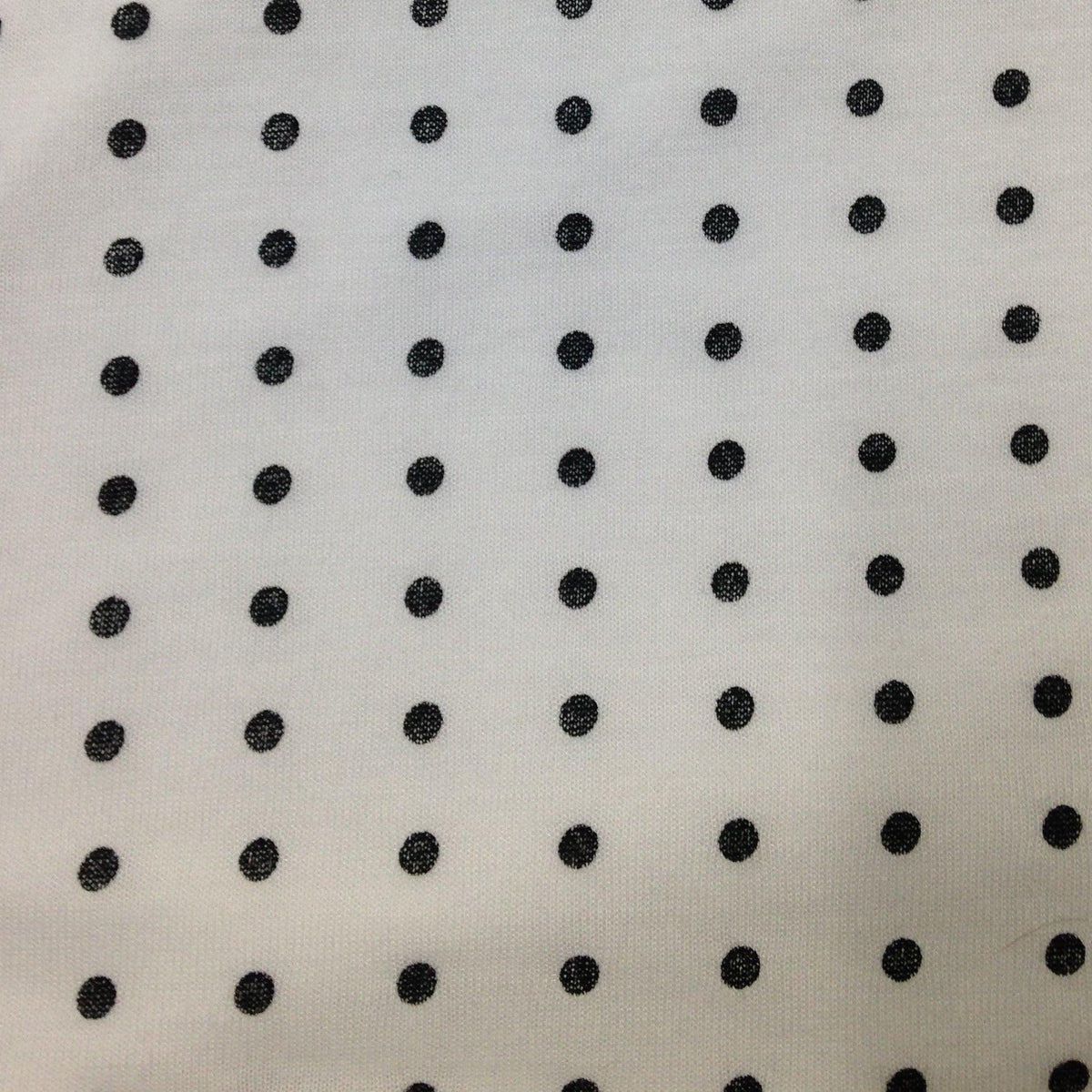 Nature's Fabrics white cotton fabric with small black polka dot print