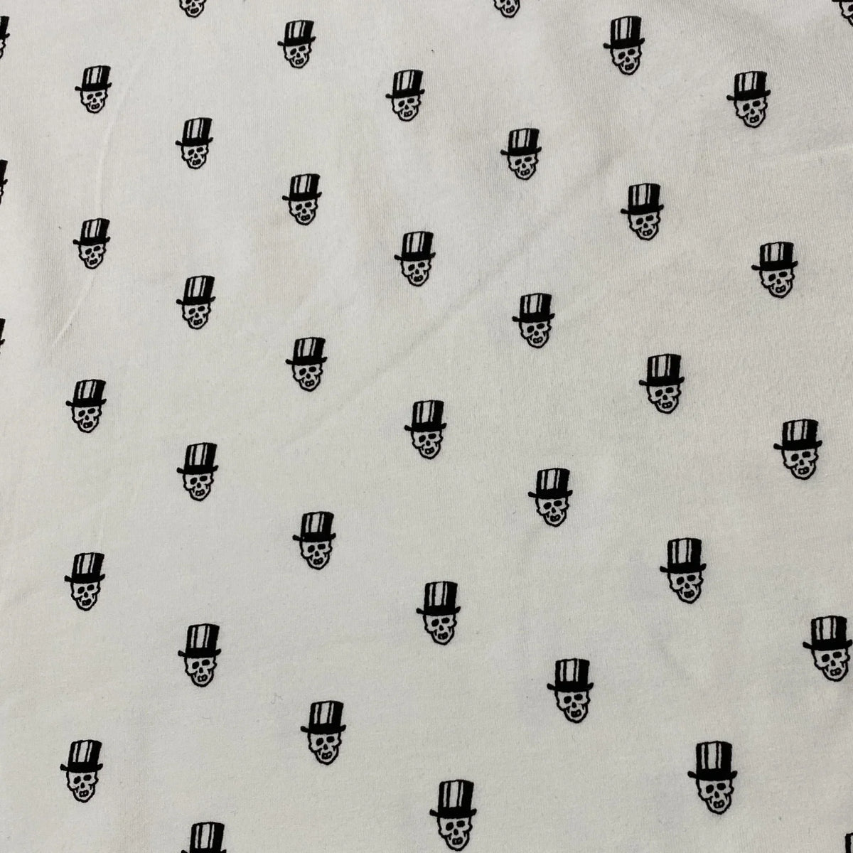 Nature's Fabrics white cotton fabric with a black skull and top hat pattern