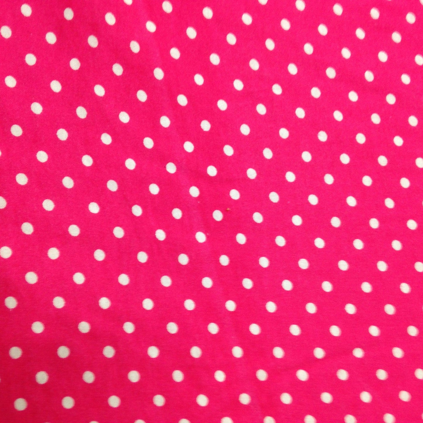 Small White Dots on Hot Pink Cotton/Poly Jersey Fabric - Nature's Fabrics