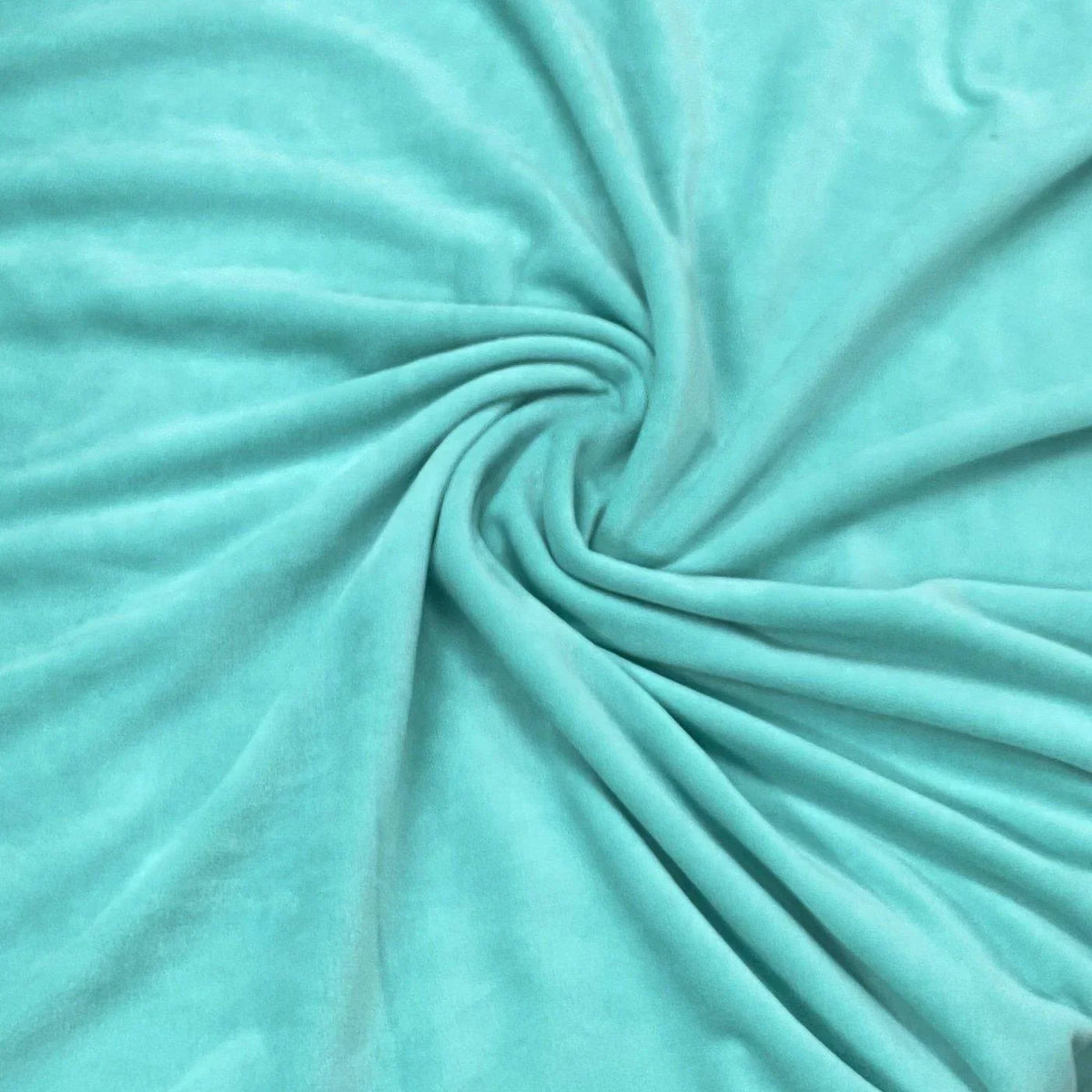 Nature's Fabrics light turquoise velvet fabric swirled into a soft spiral.