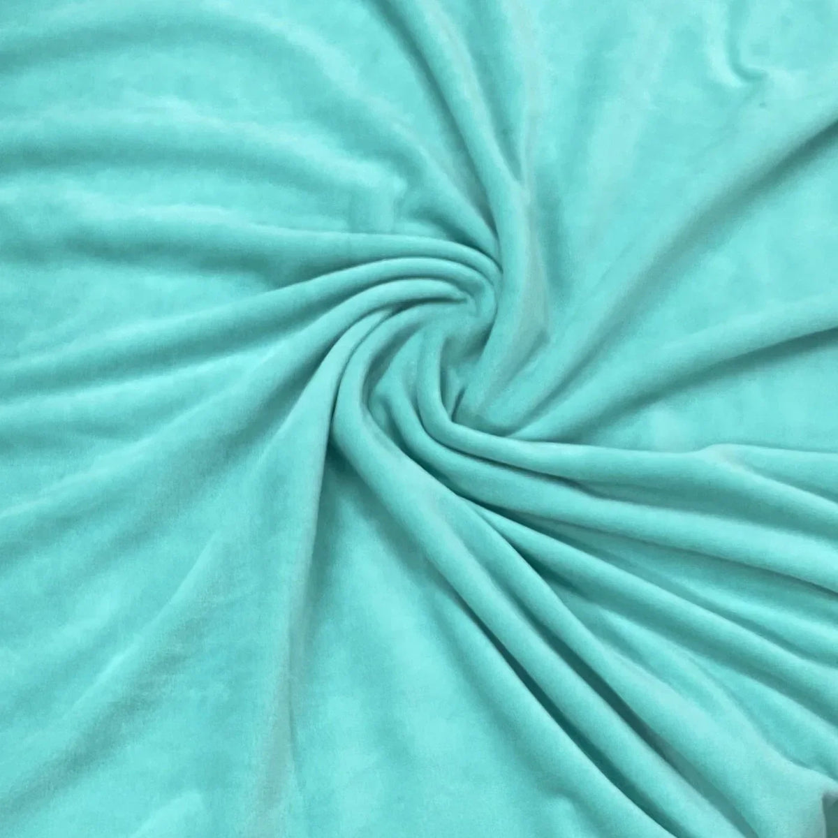 Nature's Fabrics soft teal velvet fabric draped in a spiral pattern