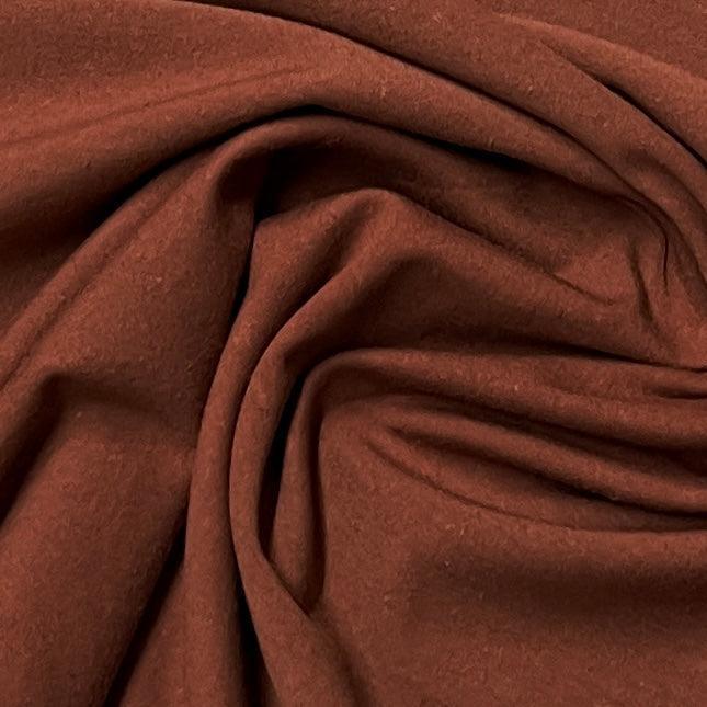 Close-up of draped rust brown natural fabric from Nature's Fabrics.
