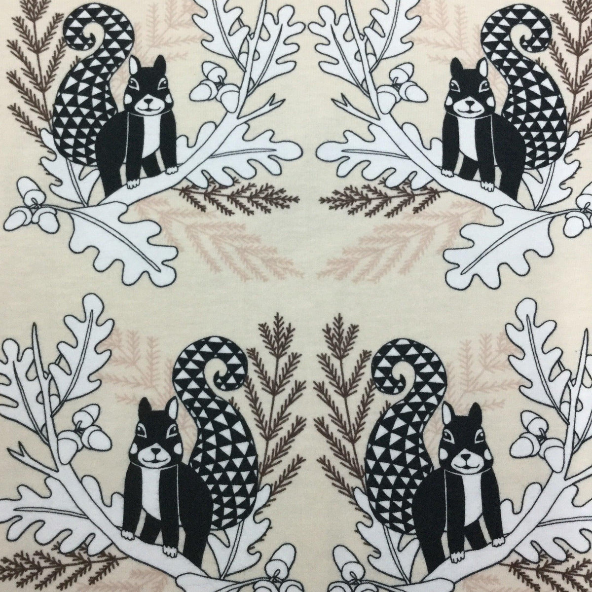Nature's Fabrics organic cotton fabric with black and white squirrel and leaf patterns.