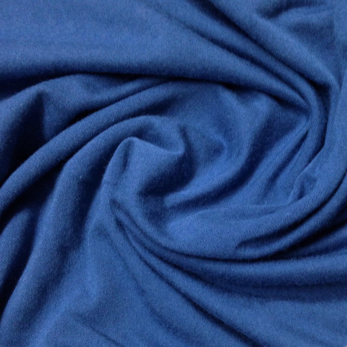 Close-up of swirled blue natural fabric from Nature's Fabrics.